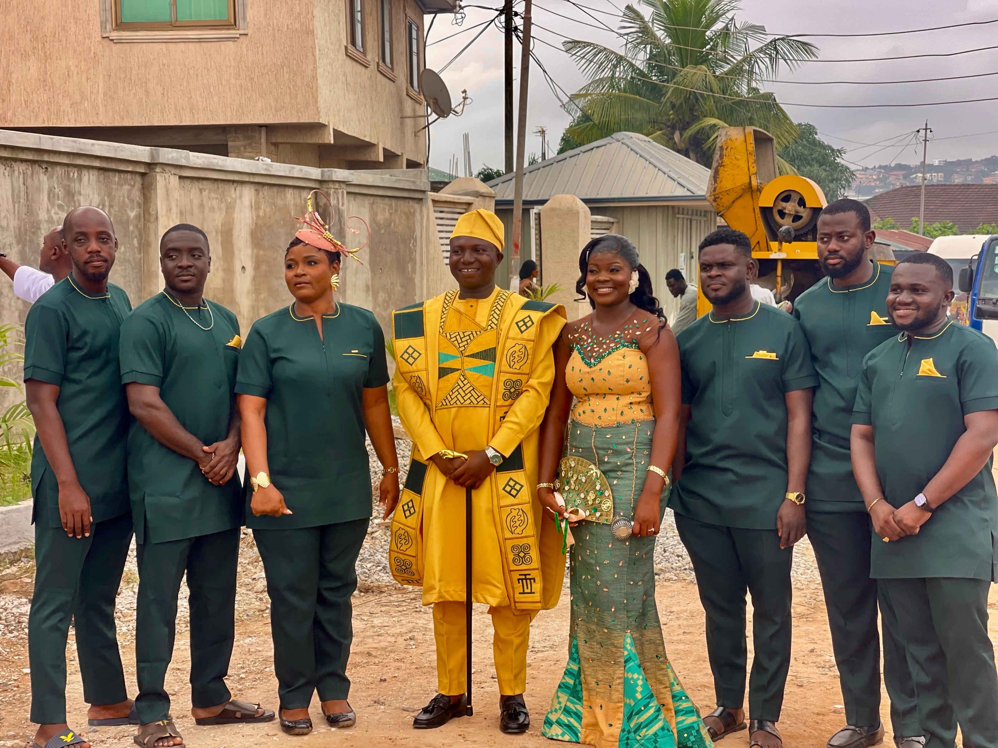 A group in matching green sets around a chief in gold